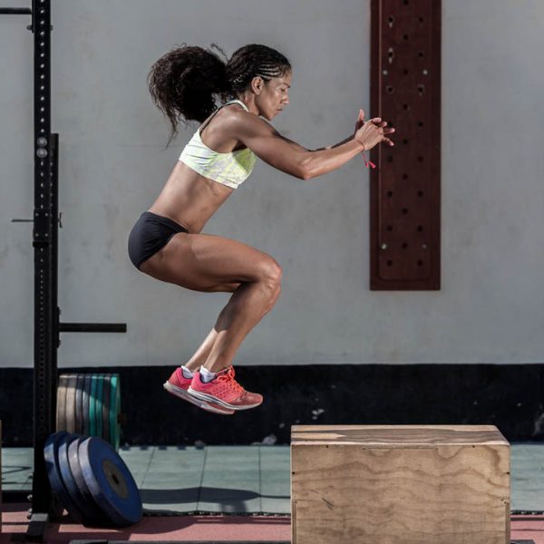 Girl jumping from stand in gym